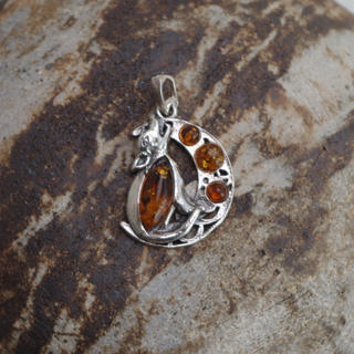 wolf howling at the moon amber pendant